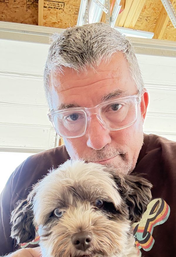 Cale in his workshop with his dog Riley
